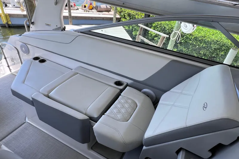 Slide: The Image of 2024 Regal 26 XO boat interior seating with cup holders and modern design. - 20