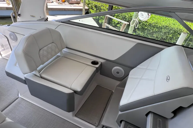 Slide: The Image of 2024 Regal 26 XO boat interior with gray seating and cup holder. - 21