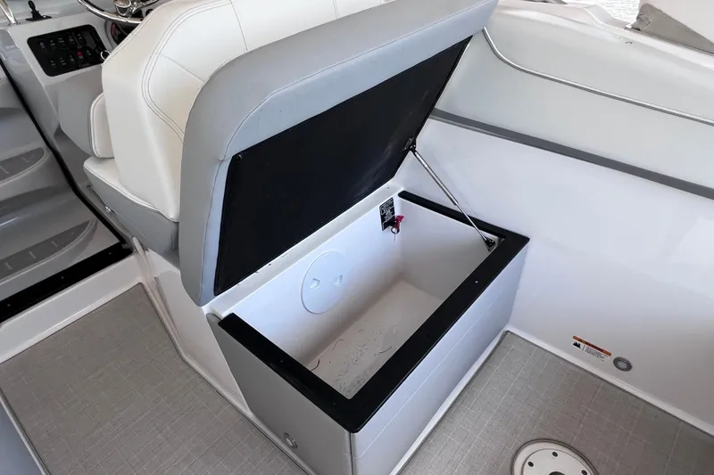 Slide: The Image of 2024 Regal 26 XO boat interior with open storage compartment under seat. - 24