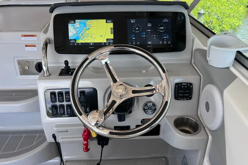 Slide: The Image of 2024 Regal 26 XO boat helm with Garmin display and modern controls. - 33