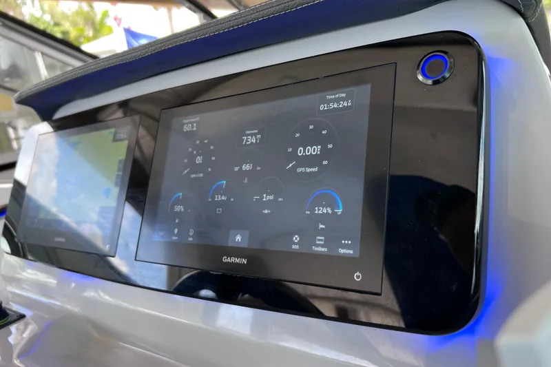 Slide: The Image of 2024 Regal 26 XO boat dashboard with Garmin display showing navigation and engine data. - 35