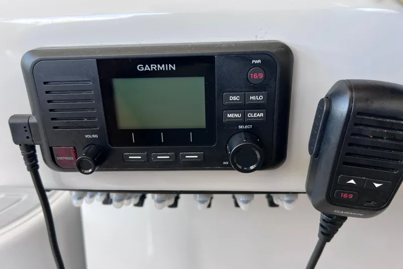 Slide: The Image of Garmin marine radio on 2024 Regal 26 XO boat dashboard. - 39