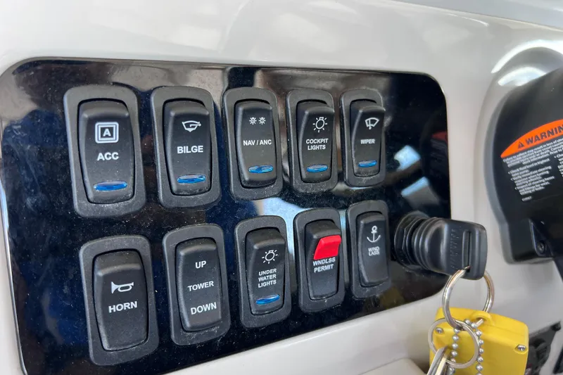Slide: The Image of Control panel of 2024 Regal 26 XO boat with labeled switches and ignition keys. - 40