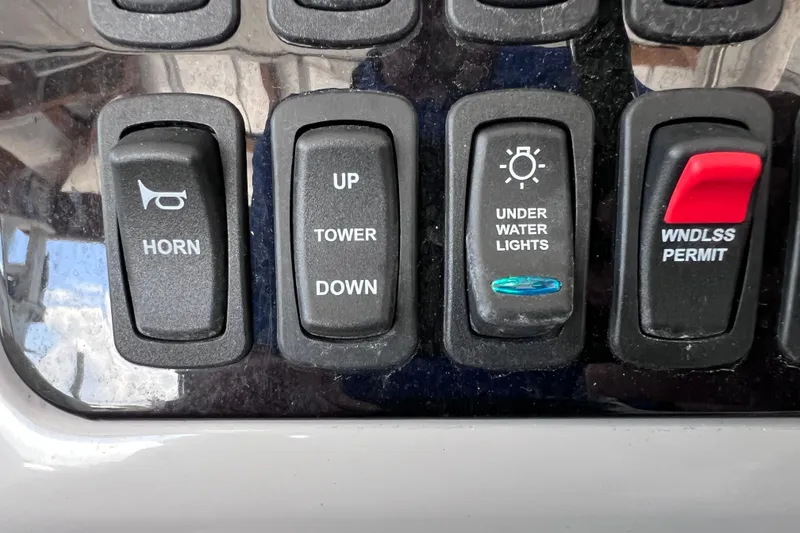 Slide: The Image of Control panel of a 2024 Regal 26 XO boat with various switches. - 41