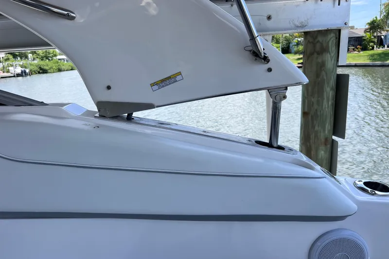 Slide: The Image of 2024 Regal 26 XO boat detail with open hatch by the water. - 42