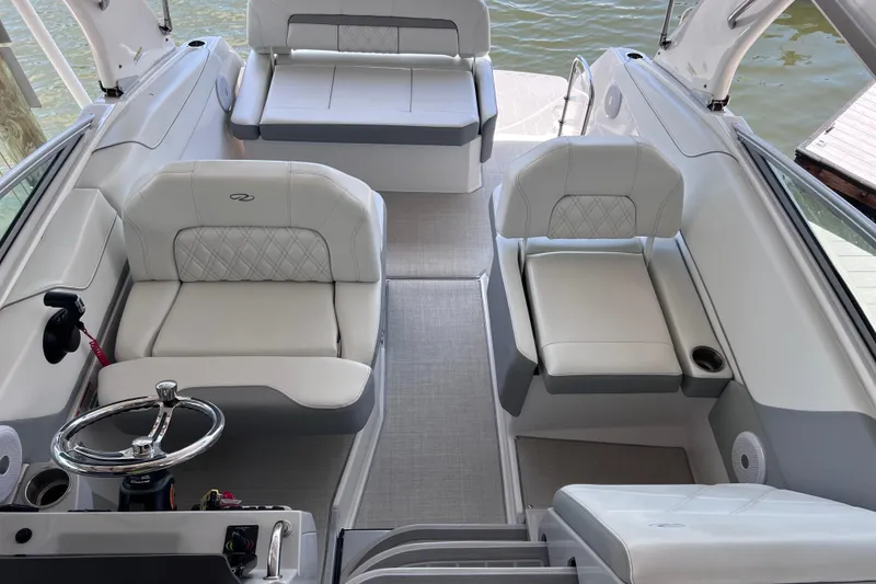 Slide: The Image of 2024 Regal 26 XO boat interior with luxurious seating and modern steering wheel. - 49