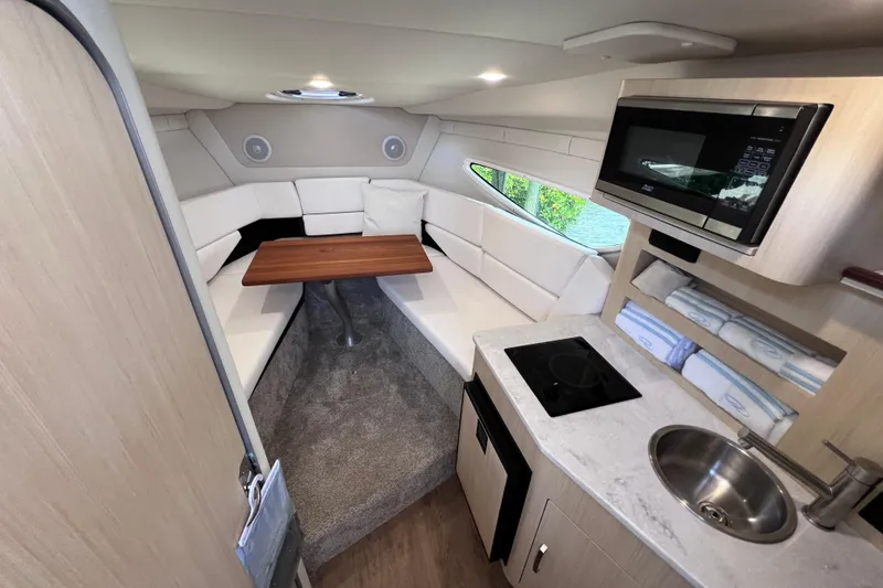 Slide: The Image of 2024 Regal 26 XO cabin interior with kitchenette, seating area, and modern amenities. - 50