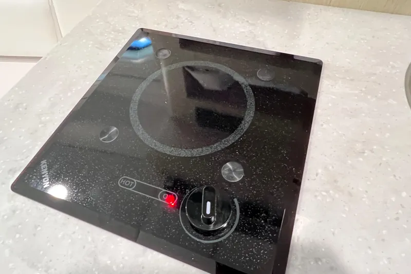 Slide: The Image of Electric cooktop on 2024 Regal 26 XO boat's countertop. - 56