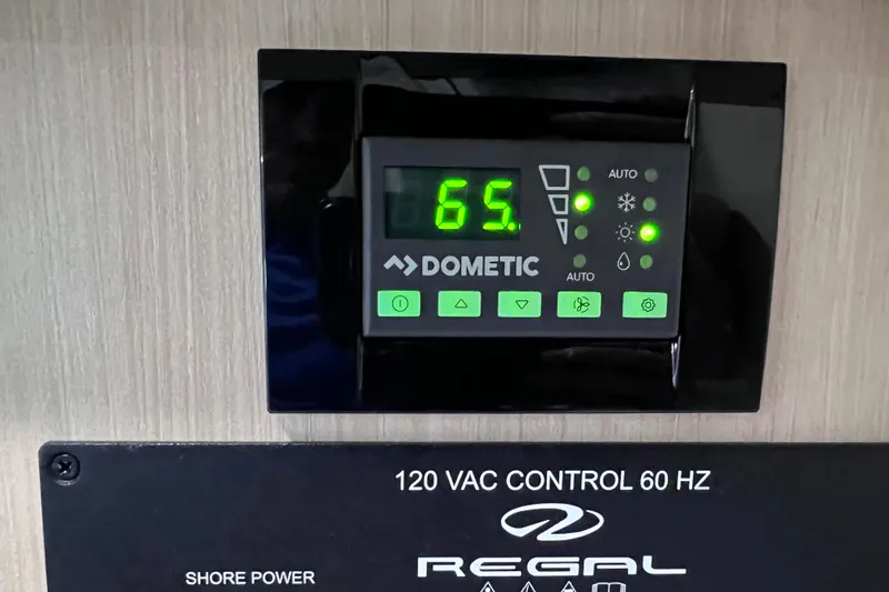 Slide: The Image of Dometic control panel on 2024 Regal 26 XO boat, displaying temperature settings. - 58