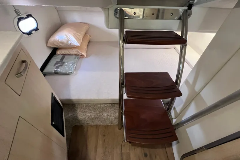 Slide: The Image of 2024 Regal 26 XO cabin interior with wooden steps and cozy sleeping area. - 59