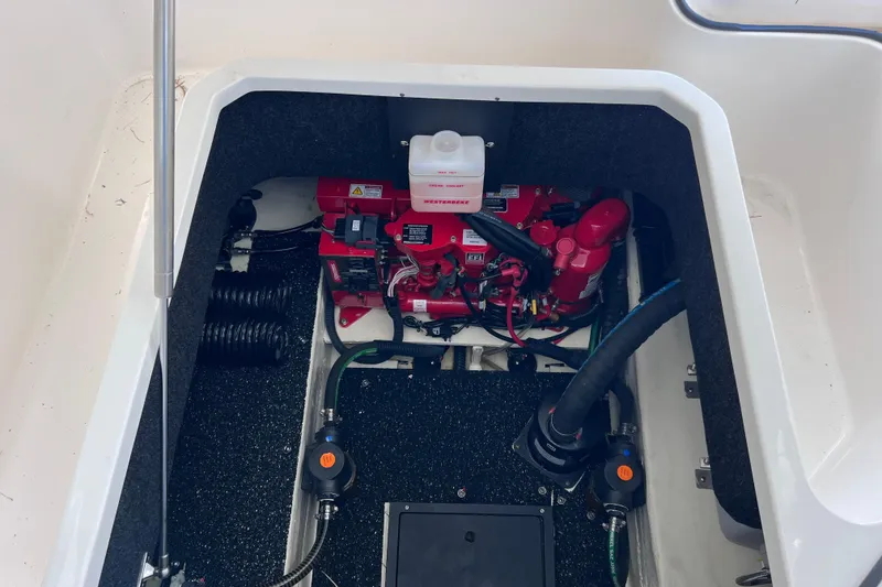 Slide: The Image of Engine compartment of 2024 Regal 26 XO boat, featuring a red generator and wiring. - 65
