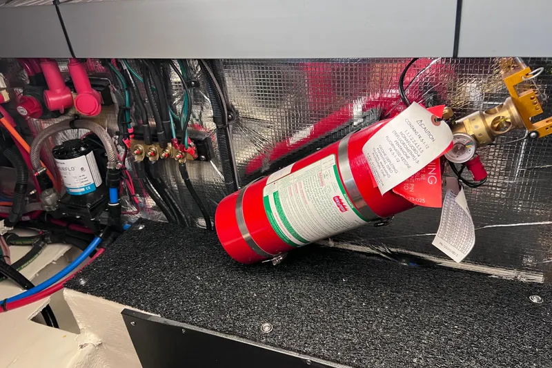 Slide: The Image of Engine compartment of 2024 Regal 26 XO with fire extinguisher and wiring. - 70