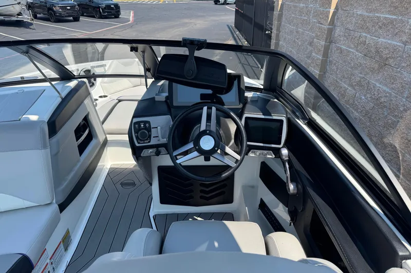 Slide: The Image of 2018 Malibu Wakesetter 23 LSV boat interior with steering wheel and dashboard controls. - 11