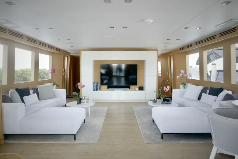 Slide: The Image of Luxurious interior of 2002 Hatteras 92 Cockpit Motor Yacht with modern decor and large windows. - 10