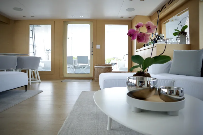 Slide: The Image of Luxurious interior of 2002 Hatteras 92 Cockpit Motor Yacht with modern decor and orchid. - 12