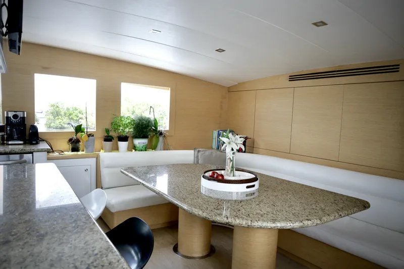 Slide: The Image of Luxurious interior of 2002 Hatteras 92 Cockpit Motor Yacht with elegant dining area. - 14