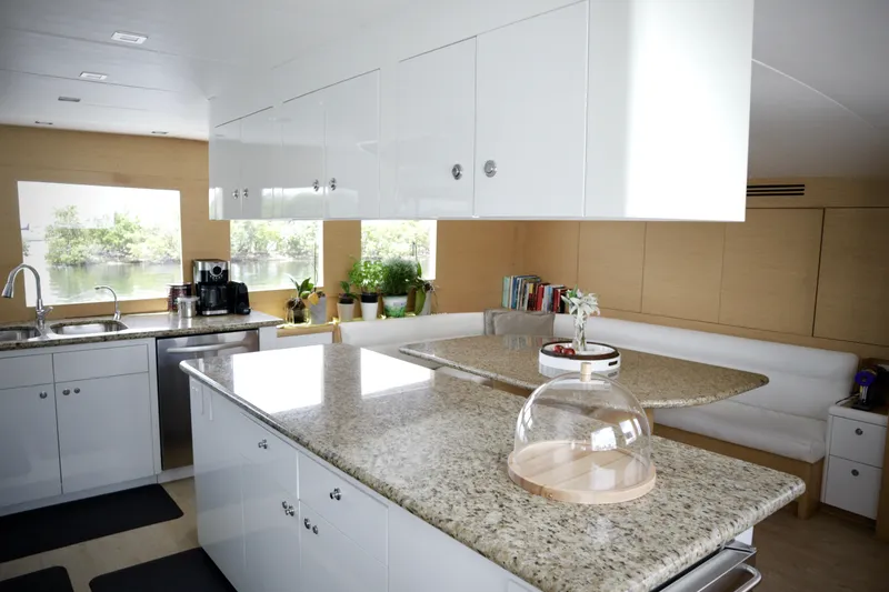 Slide: The Image of Luxurious kitchen interior of 2002 Hatteras 92 Cockpit Motor Yacht with granite countertops. - 15