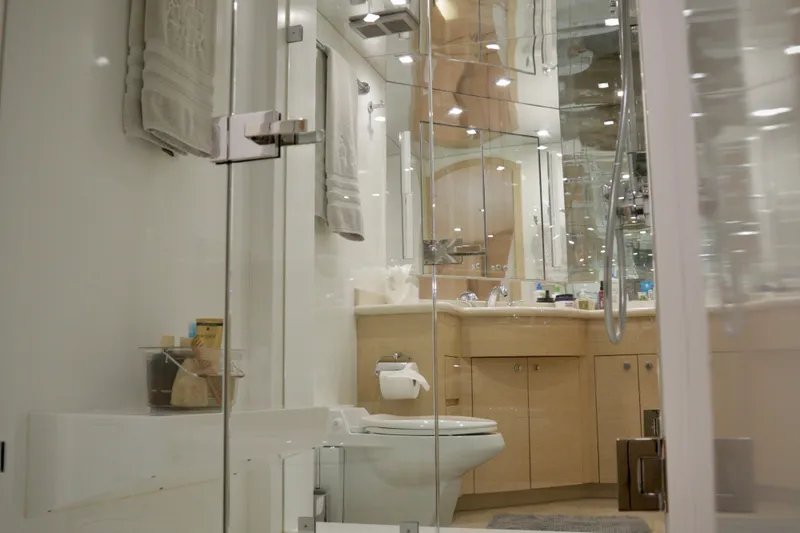 Slide: The Image of Luxurious bathroom interior on 2002 Hatteras 92 Cockpit Motor Yacht, featuring modern fixtures and elegant design. - 17