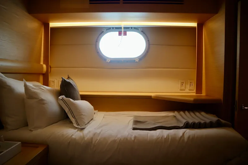 Slide: The Image of Cozy cabin interior of 2002 Hatteras 92 Cockpit Motor Yacht with porthole and plush bedding. - 20