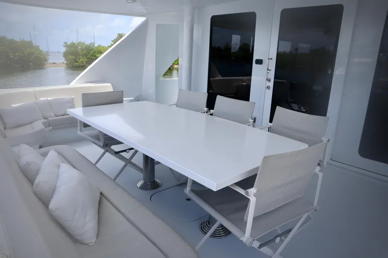 Slide: The Image of Luxurious outdoor dining area on 2002 Hatteras 92 Cockpit Motor Yacht. - 23