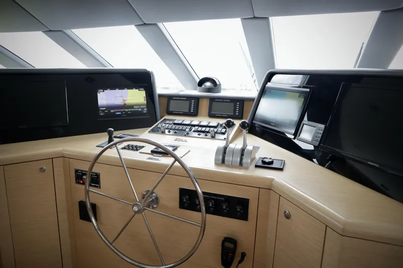 Slide: The Image of Cockpit of 2002 Hatteras 92 Cockpit Motor Yacht with navigation equipment and steering wheel. - 24