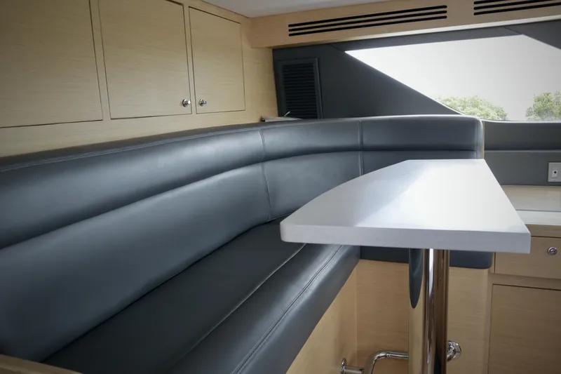 Slide: The Image of Luxurious interior of 2002 Hatteras 92 Cockpit Motor Yacht with sleek seating and modern table. - 25