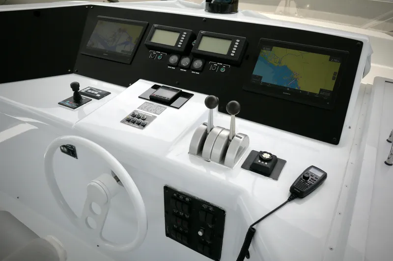 Slide: The Image of Control panel of 2002 Hatteras 92 Cockpit Motor Yacht with navigation screens and controls. - 26