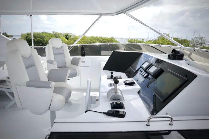 Slide: The Image of Luxurious helm of 2002 Hatteras 92 Cockpit Motor Yacht with modern navigation equipment. - 27