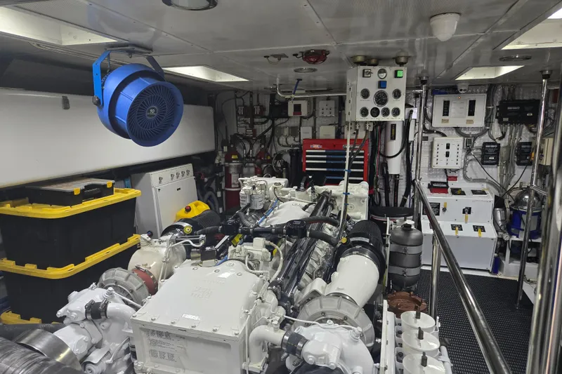 Slide: The Image of Engine room of 2002 Hatteras 92 Cockpit Motor Yacht with machinery and control panels. - 37