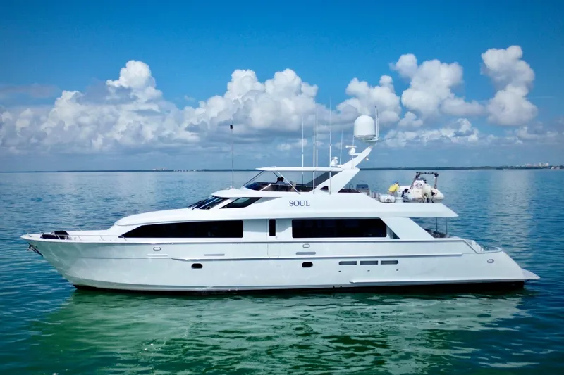 Slide: The Image of Luxury 2002 Hatteras 92 Cockpit Motor Yacht on calm ocean waters. - 4