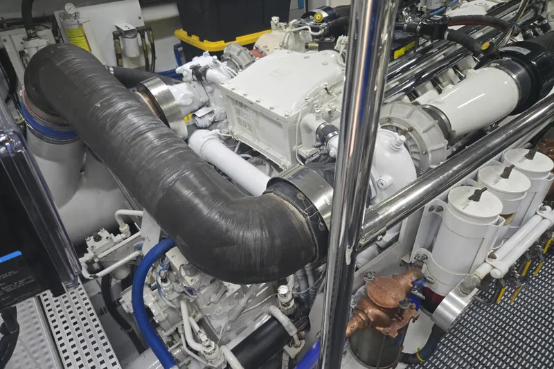 Slide: The Image of Engine room of 2002 Hatteras 92 Cockpit Motor Yacht, showcasing complex machinery and components. - 41