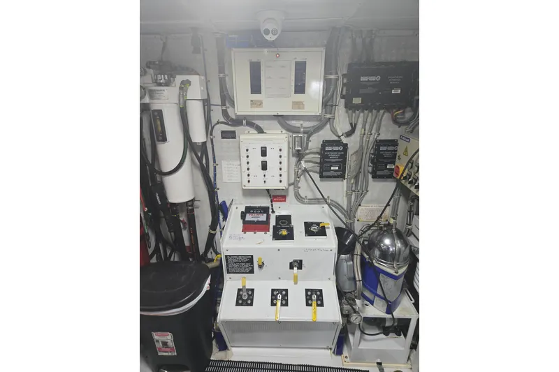 Slide: The Image of Engine room of 2002 Hatteras 92 Cockpit Motor Yacht with control panels and equipment. - 44