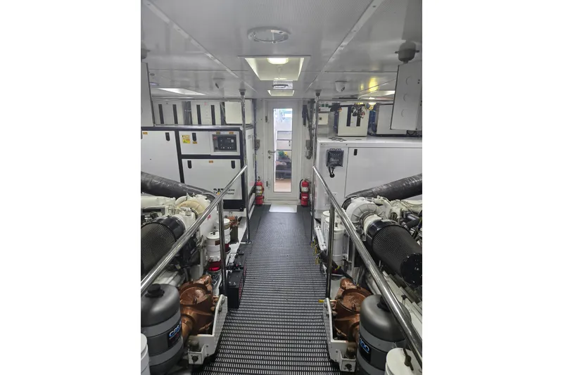 Slide: The Image of Engine room of 2002 Hatteras 92 Cockpit Motor Yacht, featuring advanced machinery and equipment. - 45
