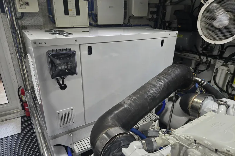 Slide: The Image of Engine room of 2002 Hatteras 92 Cockpit Motor Yacht with generator and machinery. - 48