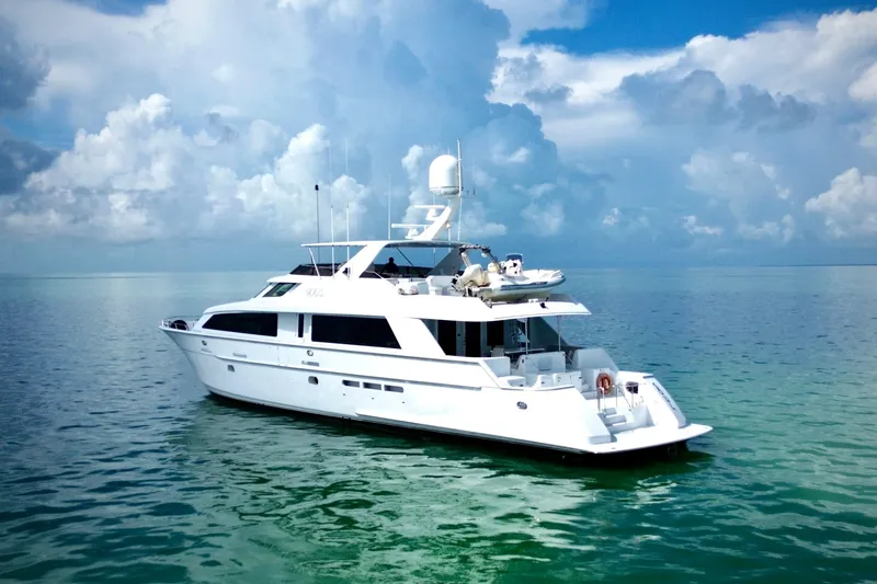 Slide: The Image of Luxurious 2002 Hatteras 92 Cockpit Motor Yacht on serene ocean waters. - 5