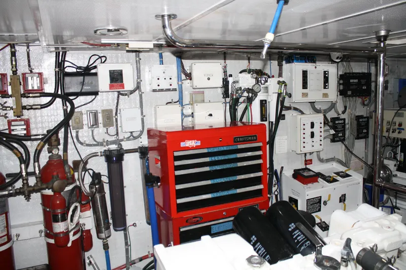Slide: The Image of Engine room of 2002 Hatteras 92 Cockpit Motor Yacht with tools and control panels. - 50