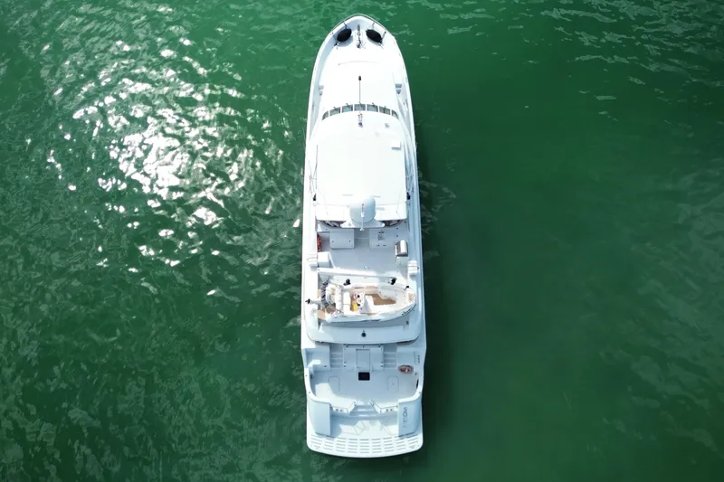 Slide: The Image of Aerial view of 2002 Hatteras 92 Cockpit Motor Yacht on green water. - 9