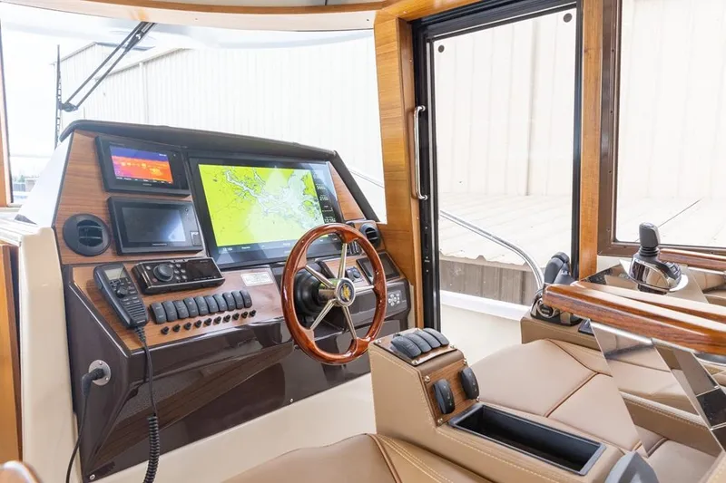 Slide: The Image of Interior helm of 2025 Ranger Tugs 43 Command Bridge with navigation screens and controls. - 12