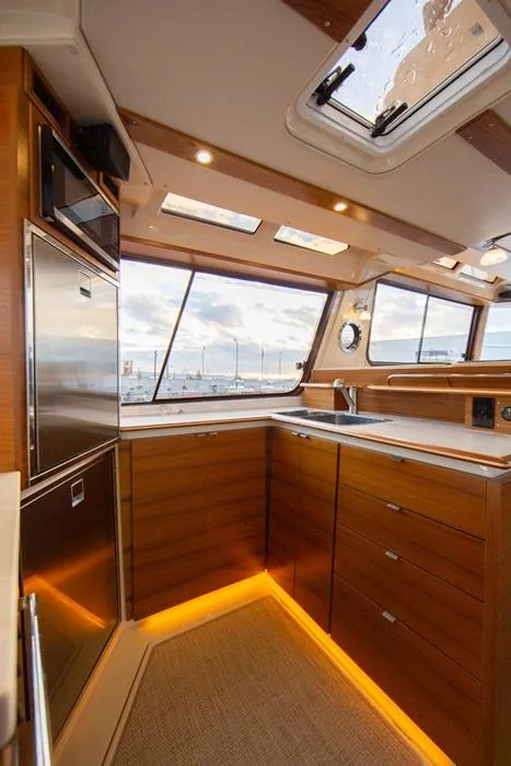 Slide: The Image of Luxurious interior of 2025 Ranger Tugs 43 Command Bridge yacht kitchen. - 16