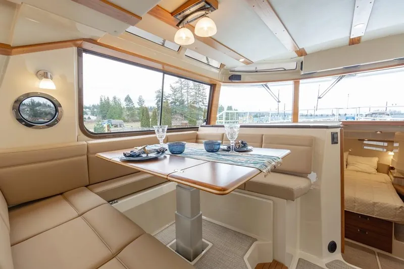 Slide: The Image of Luxurious interior of 2025 Ranger Tugs 43 Command Bridge with dining area and scenic views. - 18