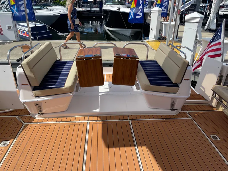 Slide: The Image of 2025 Ranger Tugs 43 Command Bridge with teak deck and cushioned seating. - 2