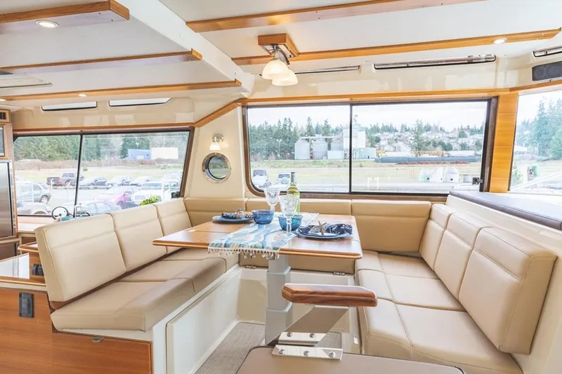 Slide: The Image of Luxurious interior of 2025 Ranger Tugs 43 Command Bridge with spacious seating and dining area. - 22