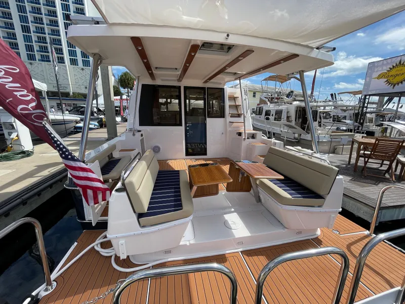 Slide: The Image of 2025 Ranger Tugs 43 Command Bridge yacht with spacious deck and seating area. - 4