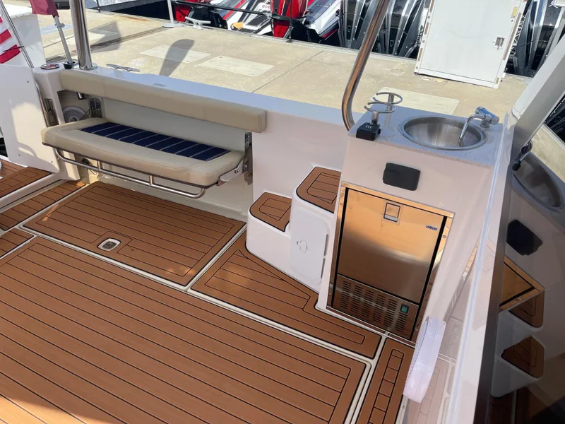 Slide: The Image of 2025 Ranger Tugs 43 Command Bridge deck with seating, sink, and storage. - 6