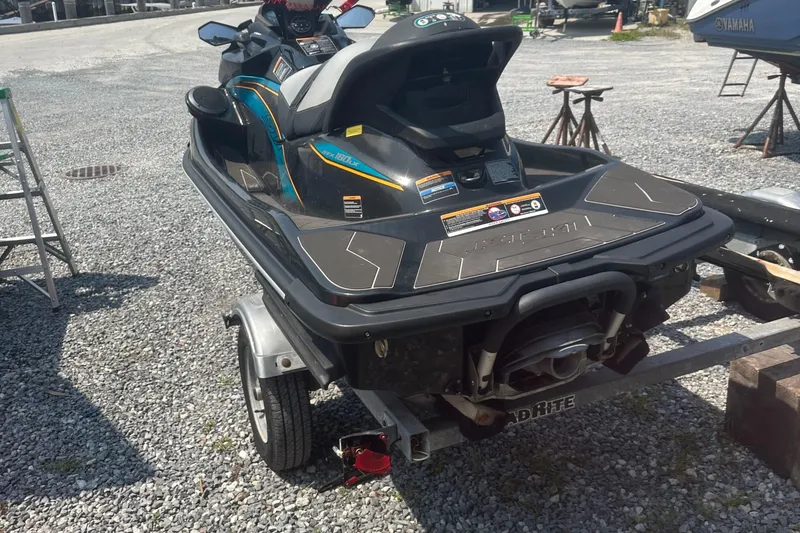 Slide: The Image of 2022 Kawasaki Jetski STX 160LX on trailer, parked on gravel lot. - 5