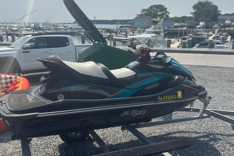 Slide: The Image of 2022 Kawasaki Jetski STX 160LX on trailer at marina, sunny day. - 8