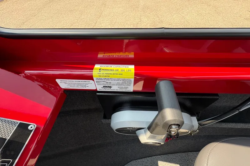 Slide: The Image of Red 2026 Lund 185 HG boat interior with capacity label and control handle. - 18