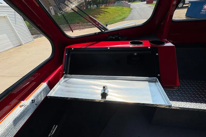 Slide: The Image of Interior of 2026 Lund 185 HG boat with open storage compartment and cup holders. - 20