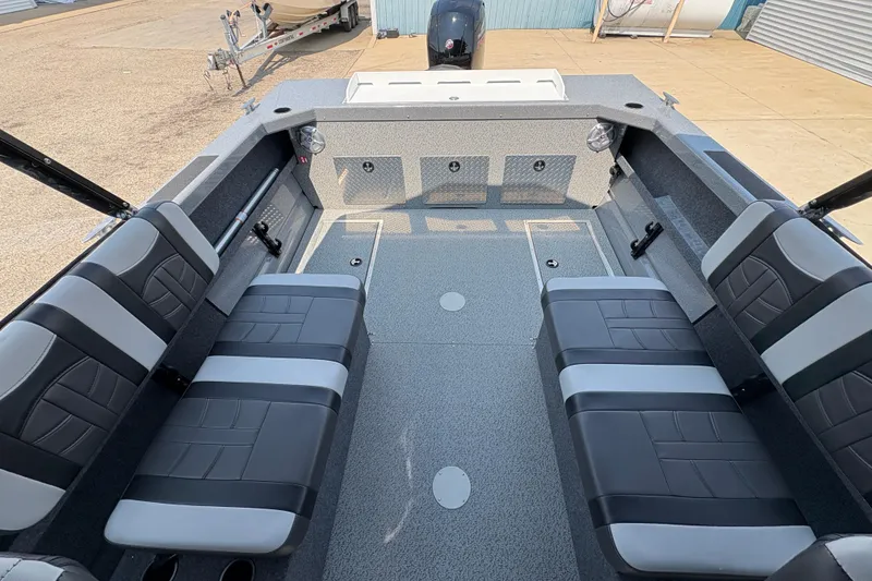 Slide: The Image of 2026 Lund 185 HG boat interior with black and gray seating, spacious layout. - 22