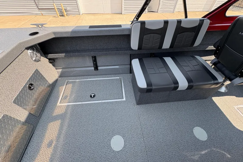 Slide: The Image of Interior of 2026 Lund 185 HG boat with gray seating and storage compartments. - 25